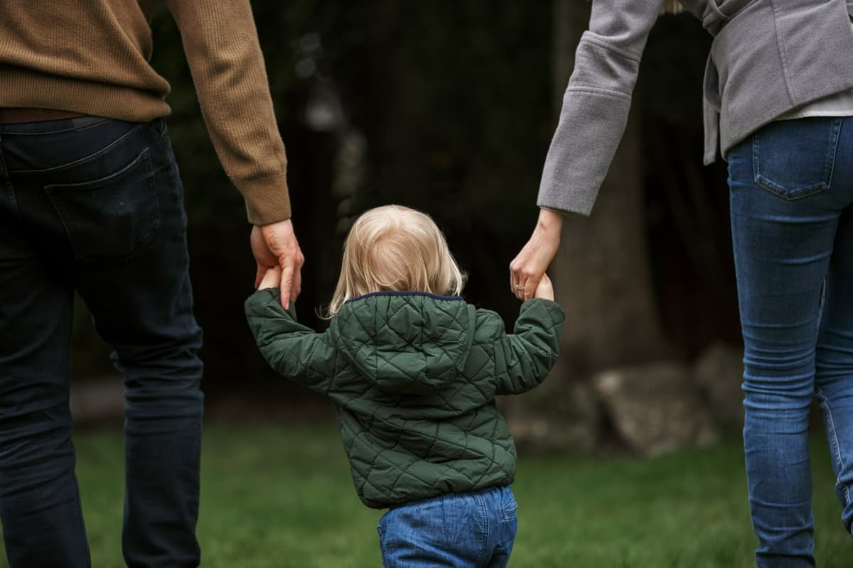 Parent holding child's hand