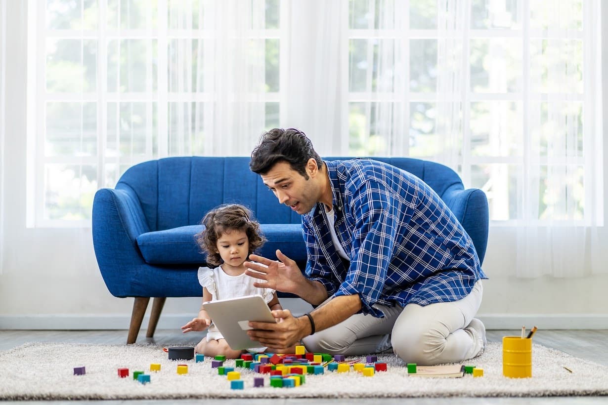 Parent and child playing with blocks on the floor